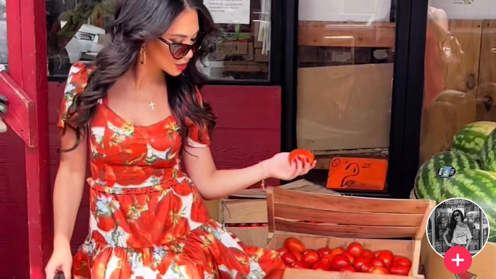 TikToker shares her fashionable tomato girl summer attire while posing with the tasty red fruit.